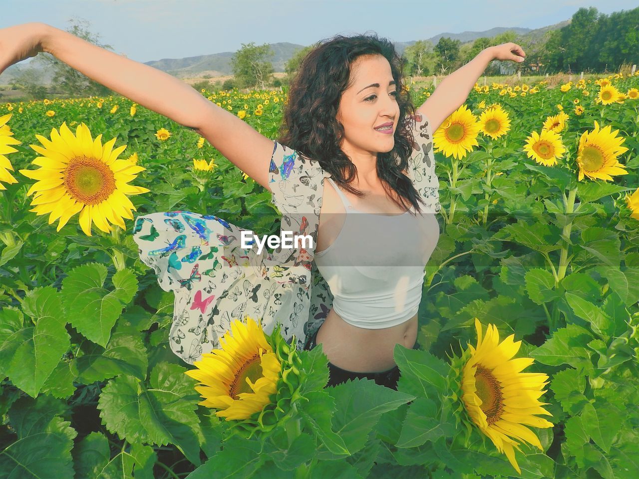 YOUNG WOMAN WITH YELLOW FLOWERS