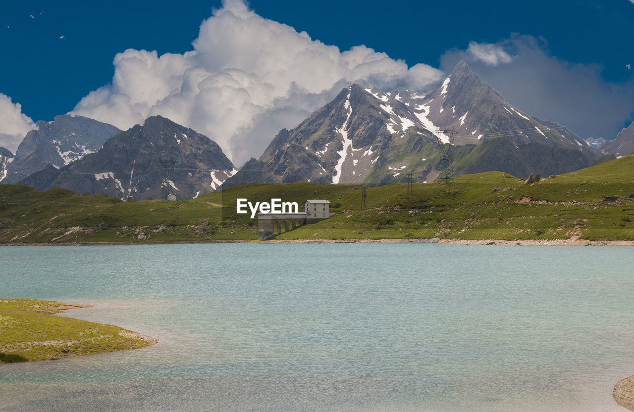 Panoramic view of castel lake with alps in the background in piedmont