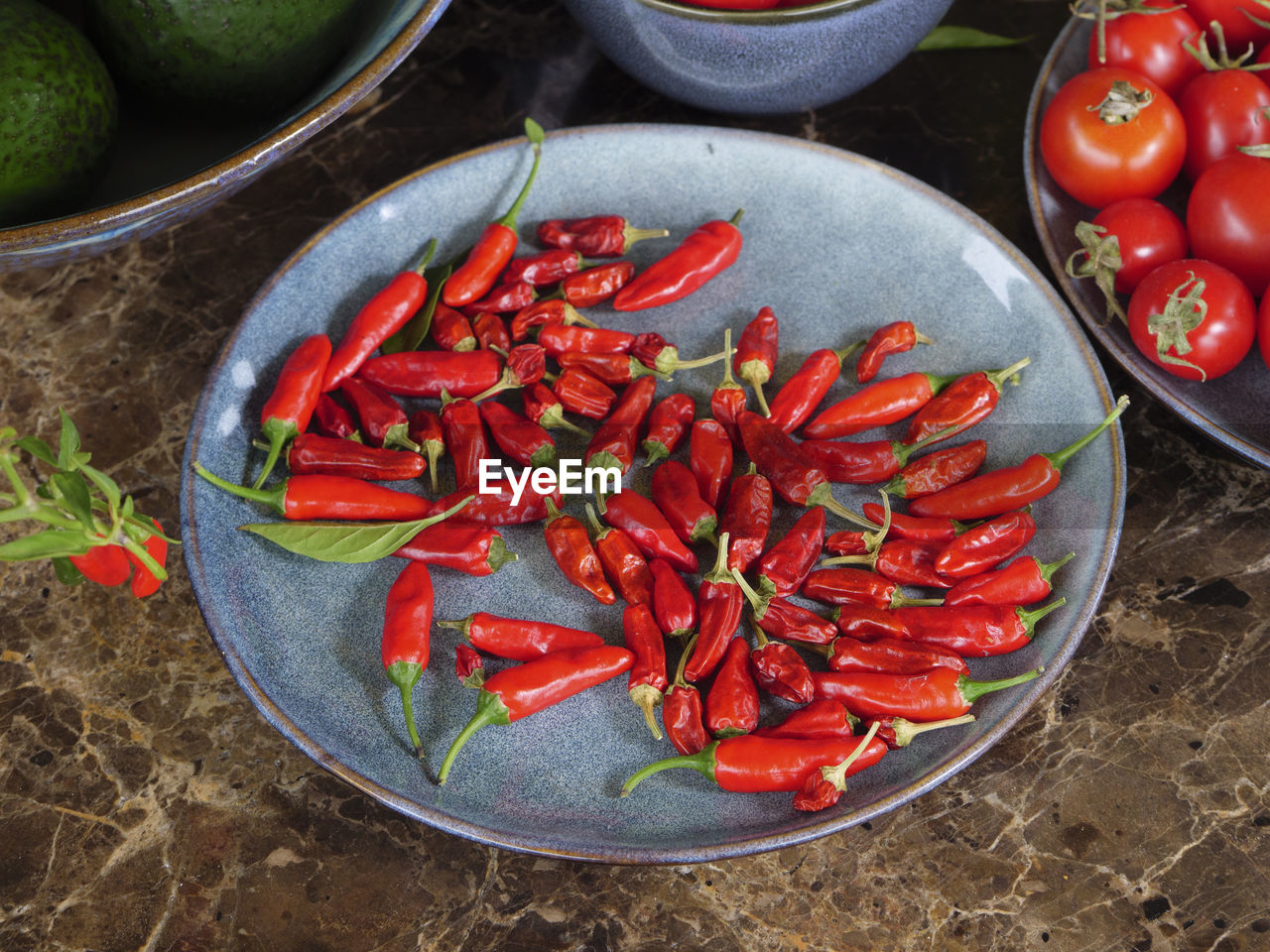 High angle view of red chili peppers in bowl