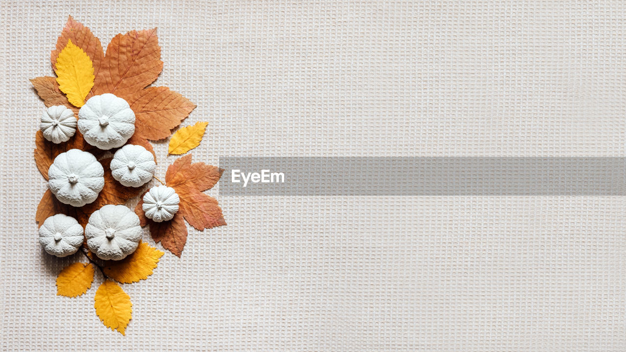 Autumn creative craft background web banner with decorative clay pumpkins and wooden autumn leaves