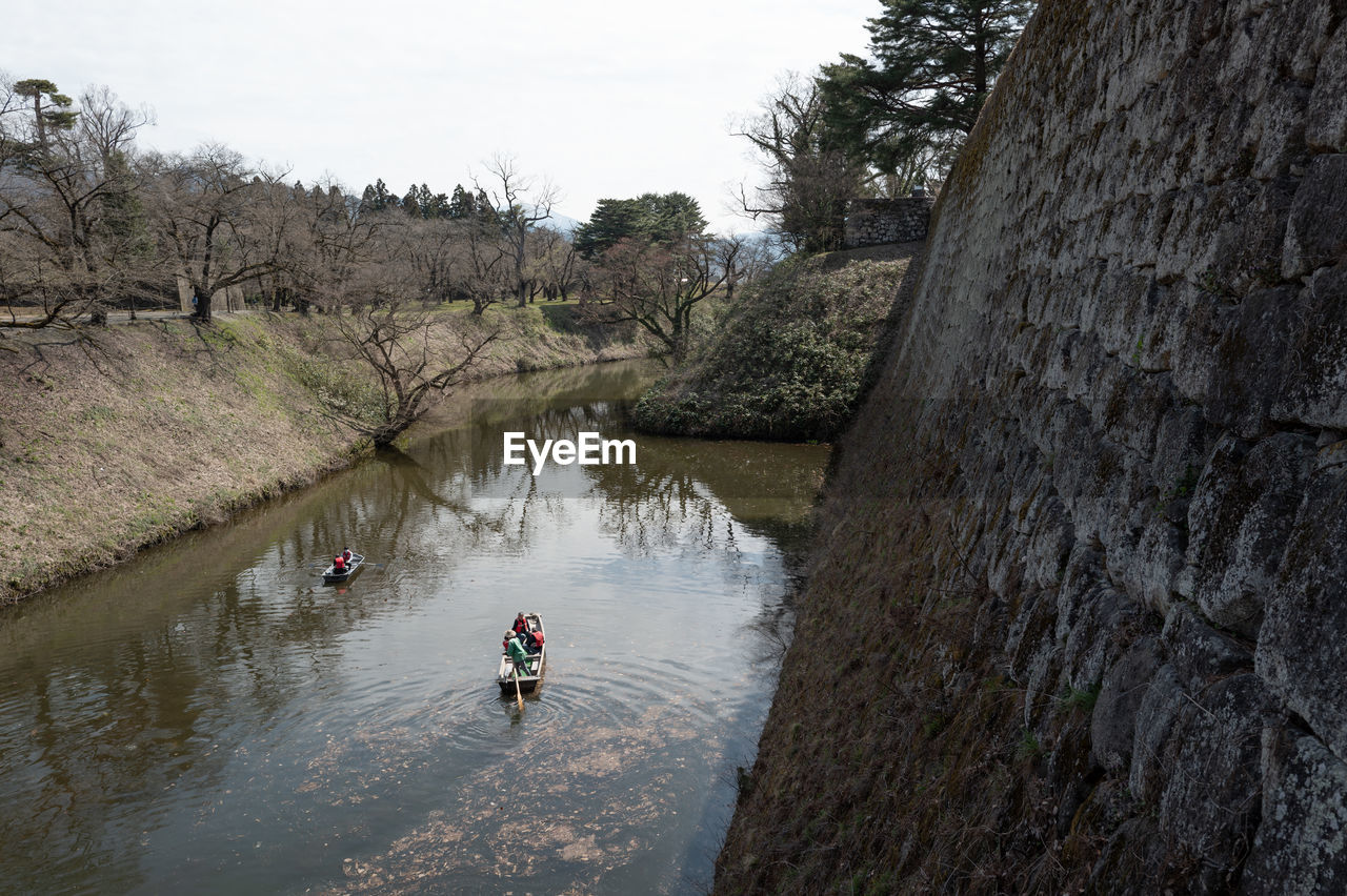 water, river, tree, waterway, nature, plant, men, day, lifestyles, adult, leisure activity, outdoors, transportation, nautical vessel, body of water, reflection, sky, sports, high angle view, full length, beauty in nature, one person, travel