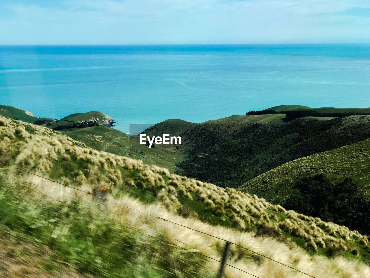 Scenic view of sea and mountains against sky