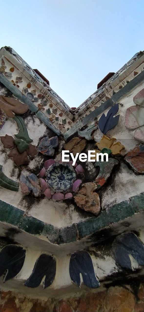 LOW ANGLE VIEW OF GRAFFITI ON STONE WALL AGAINST SKY