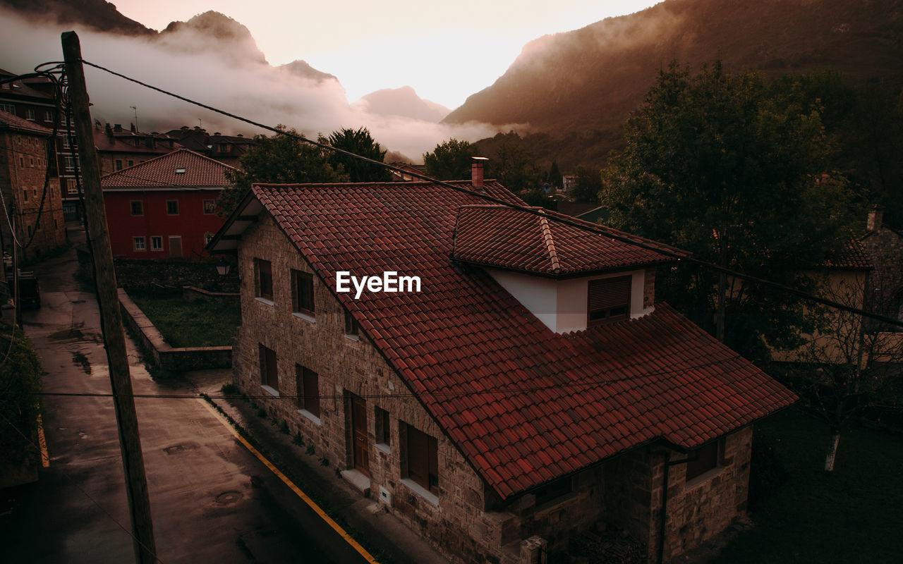 High angle view of houses and buildings in town at sunrise