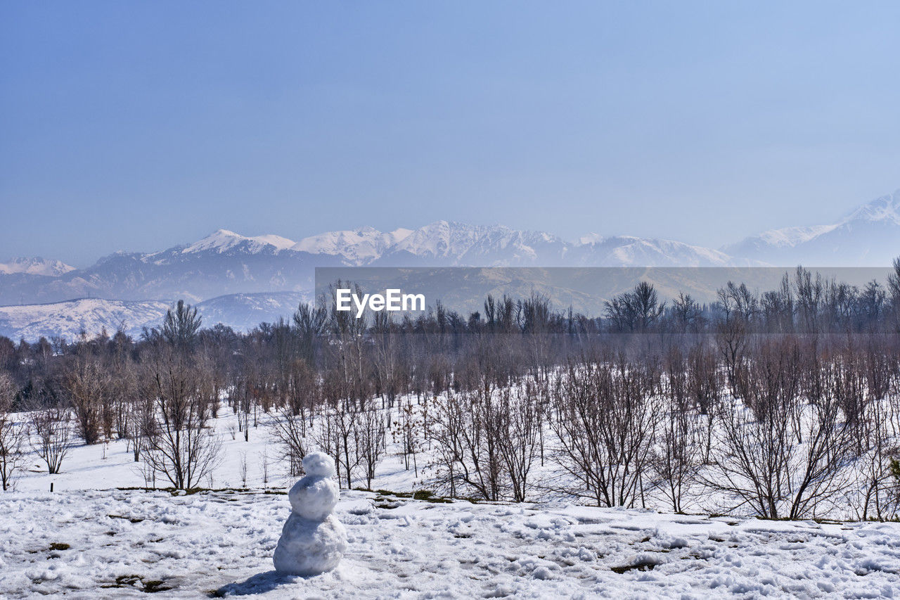 Park of first president, almaty, kazakhstan. snowman and mountains of the zaili alatau