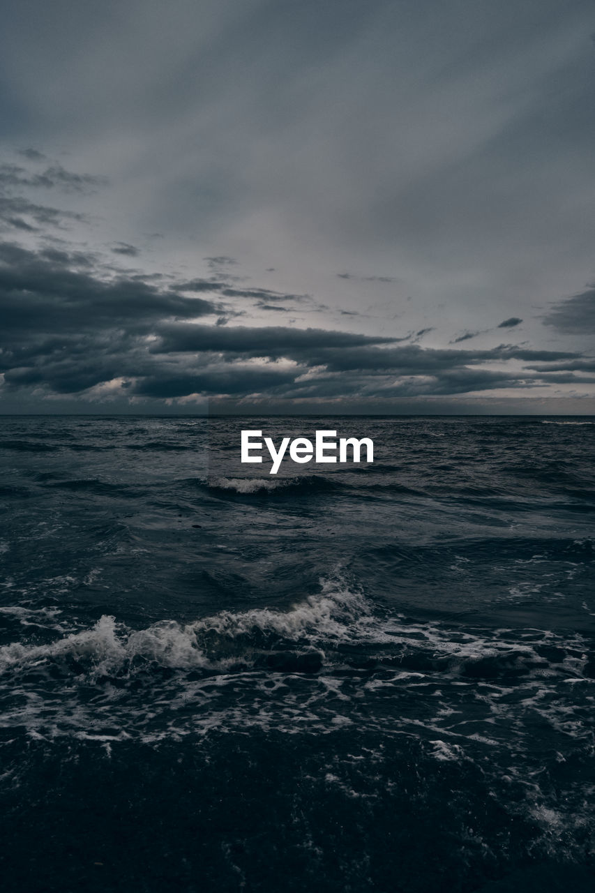 Dramatic view of an empty sea with heavy clouds and rough waves.