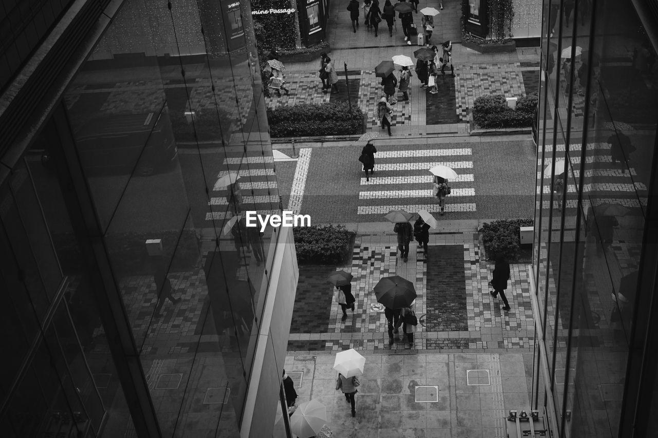 HIGH ANGLE VIEW OF PEOPLE WALKING ON STAIRS