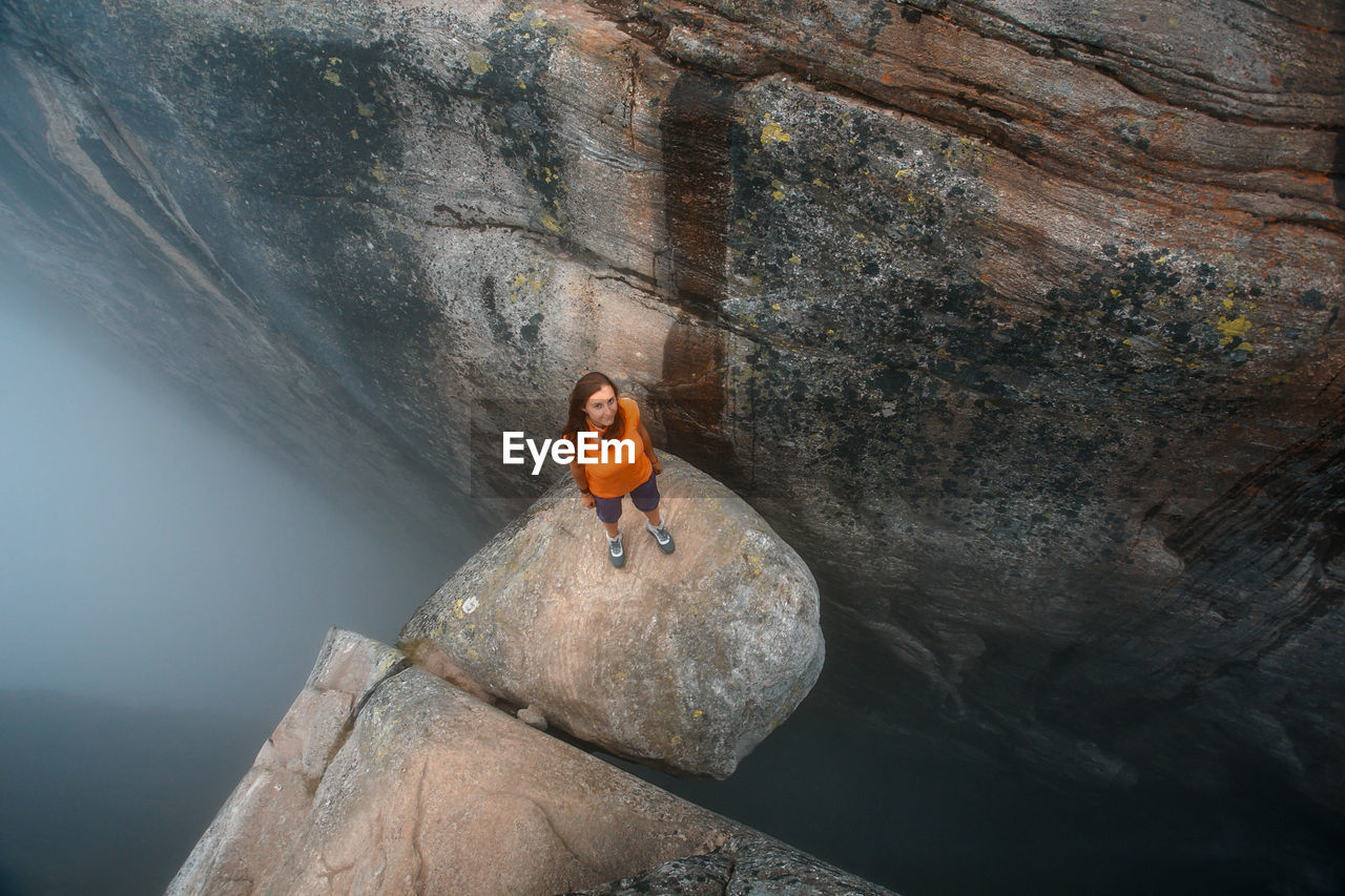 Portrait of woman standing on rock