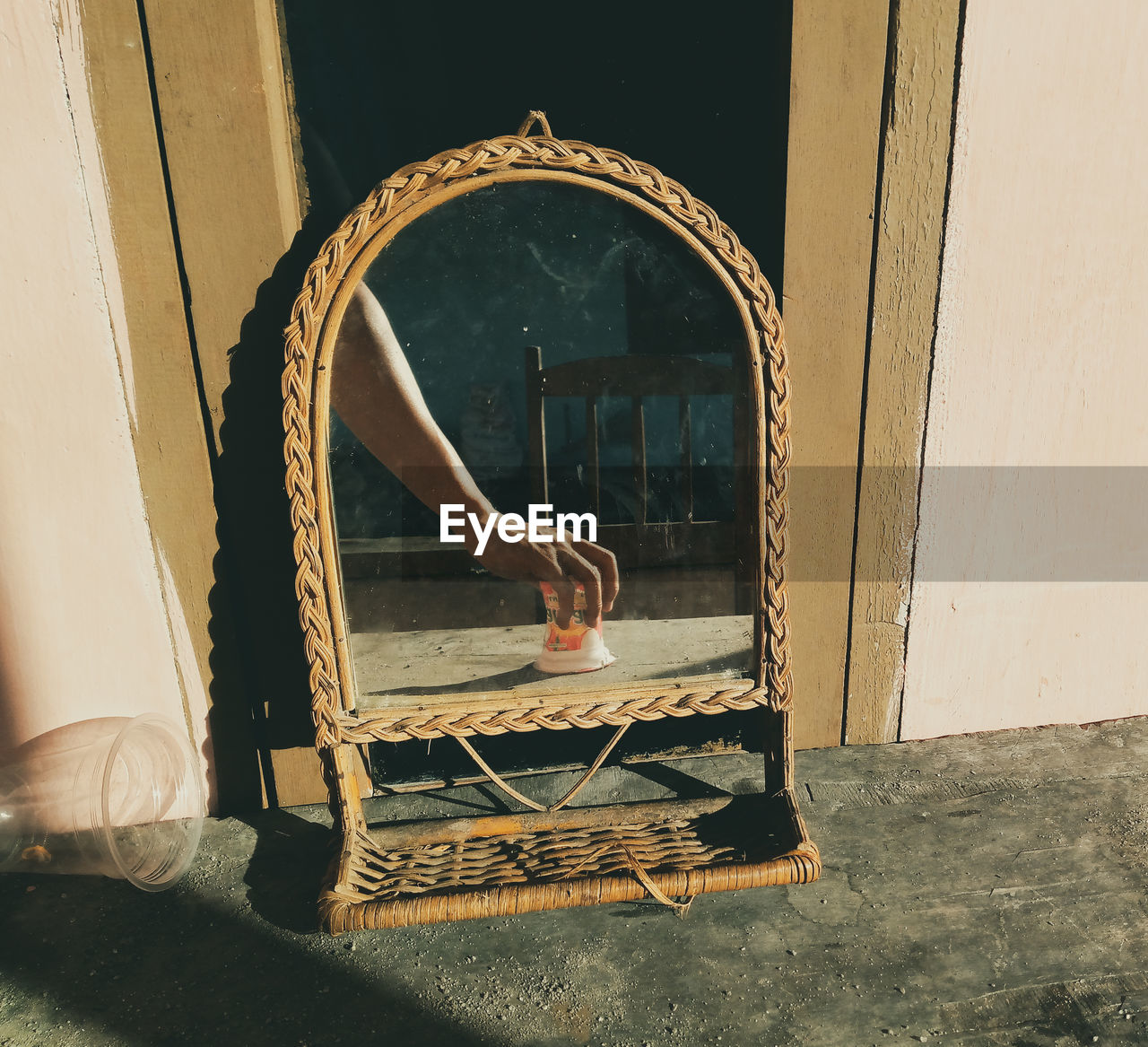 LOW SECTION OF MAN RELAXING ON WOODEN DOOR