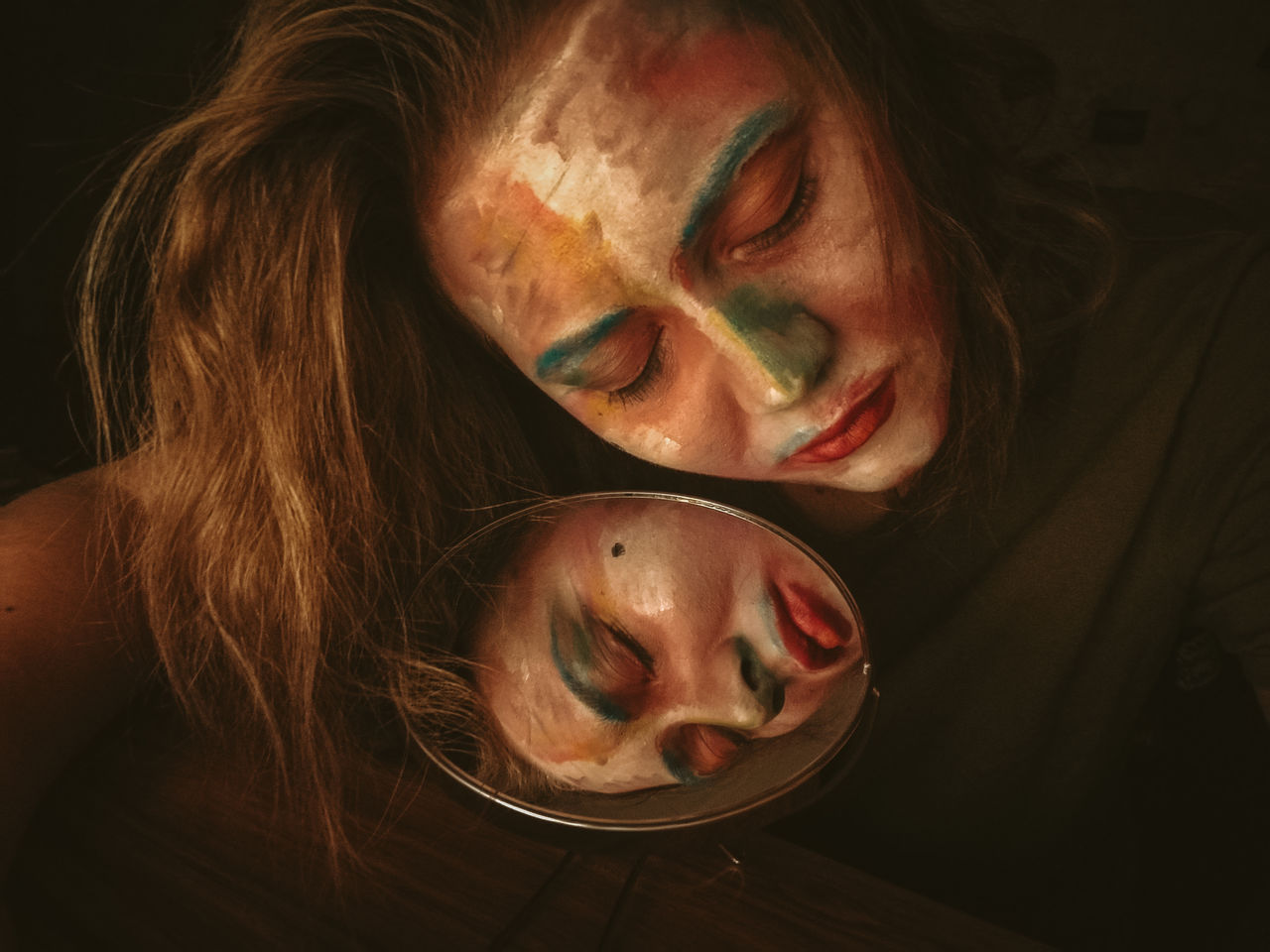 Close-up of woman with multi colored face paint