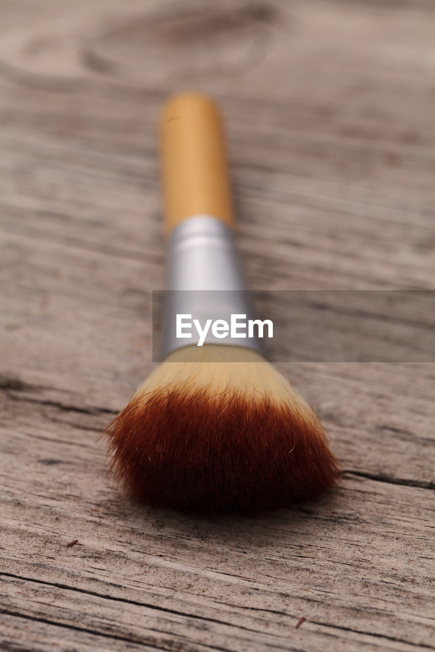 Close-up of make-up brush on table