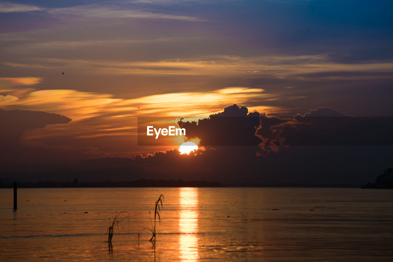 SCENIC VIEW OF SEA AGAINST ORANGE SKY DURING SUNSET