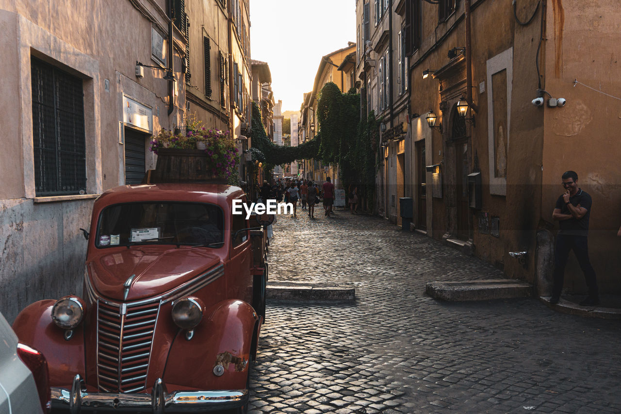 CARS ON STREET AMIDST BUILDINGS IN CITY