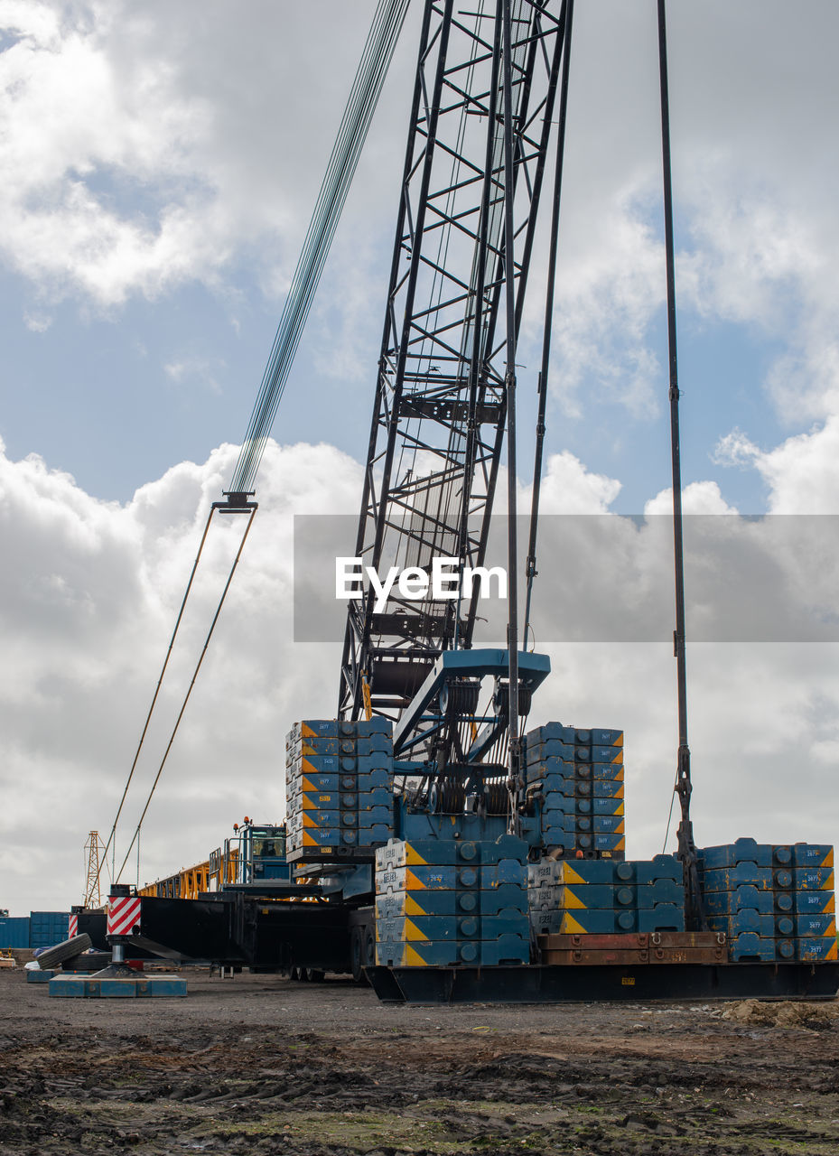 LOW ANGLE VIEW OF CRANE AT CONSTRUCTION SITE