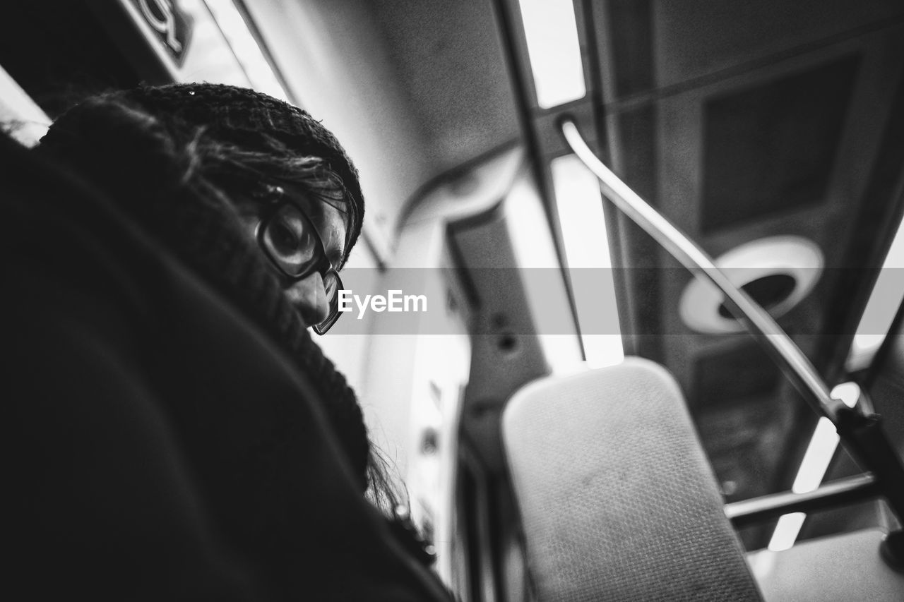 Low angle view of woman sitting in train