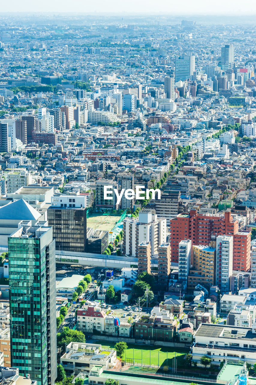 HIGH ANGLE VIEW OF BUILDINGS AND CITY IN BACKGROUND