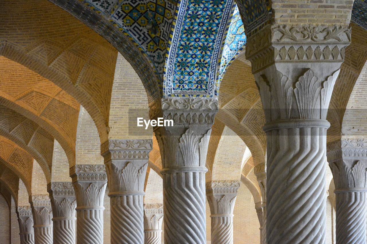 LOW ANGLE VIEW OF ARCHITECTURAL COLUMNS OF BUILDING