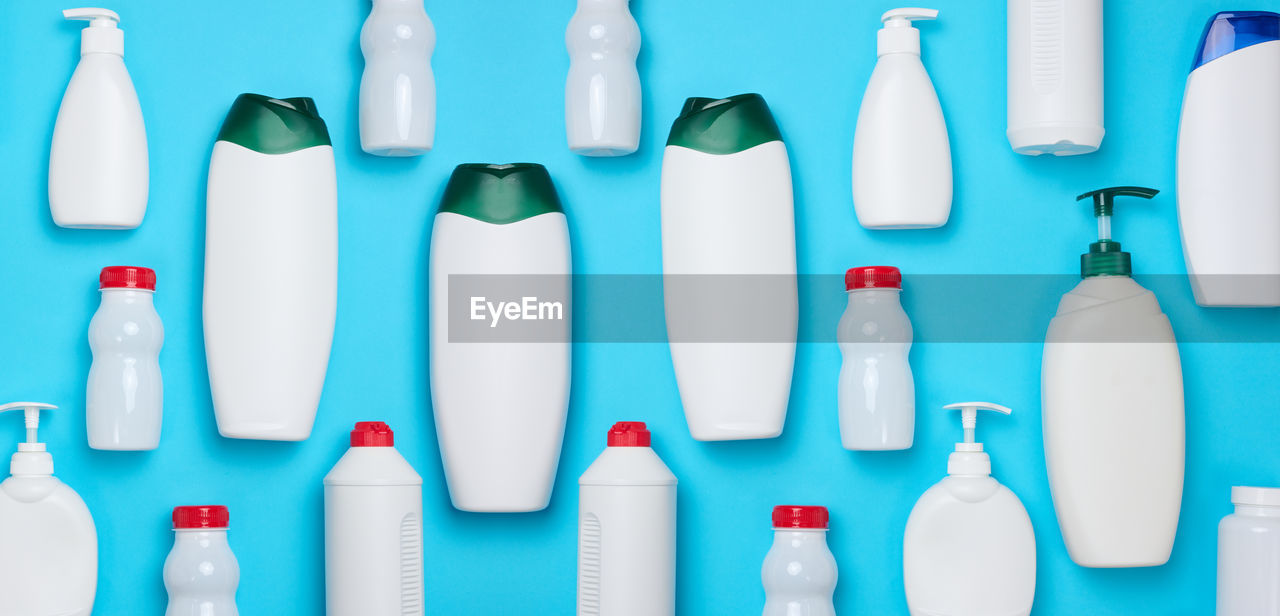 Empty plastic white bottles for cosmetics and other liquid substances on a blue background. blank 