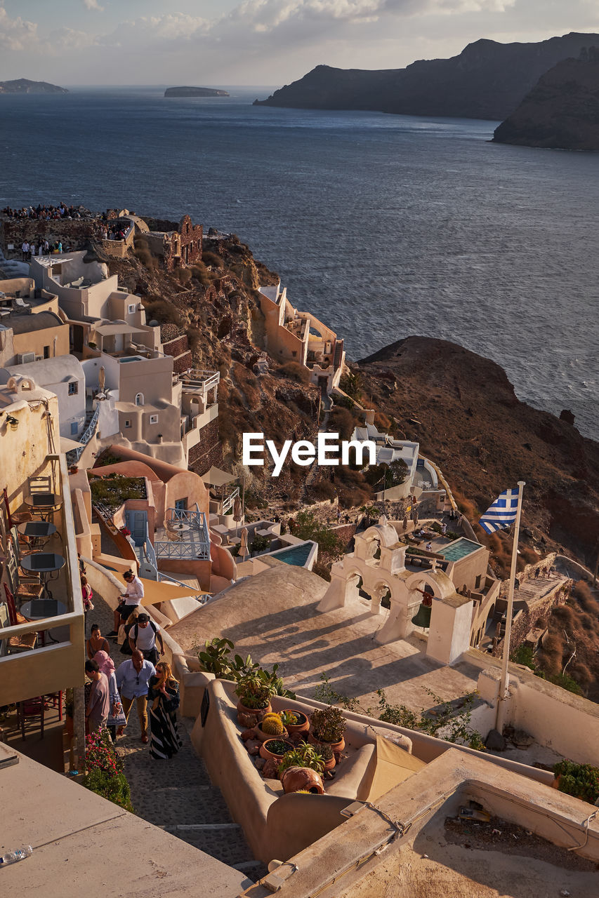 high angle view of buildings by sea against sky