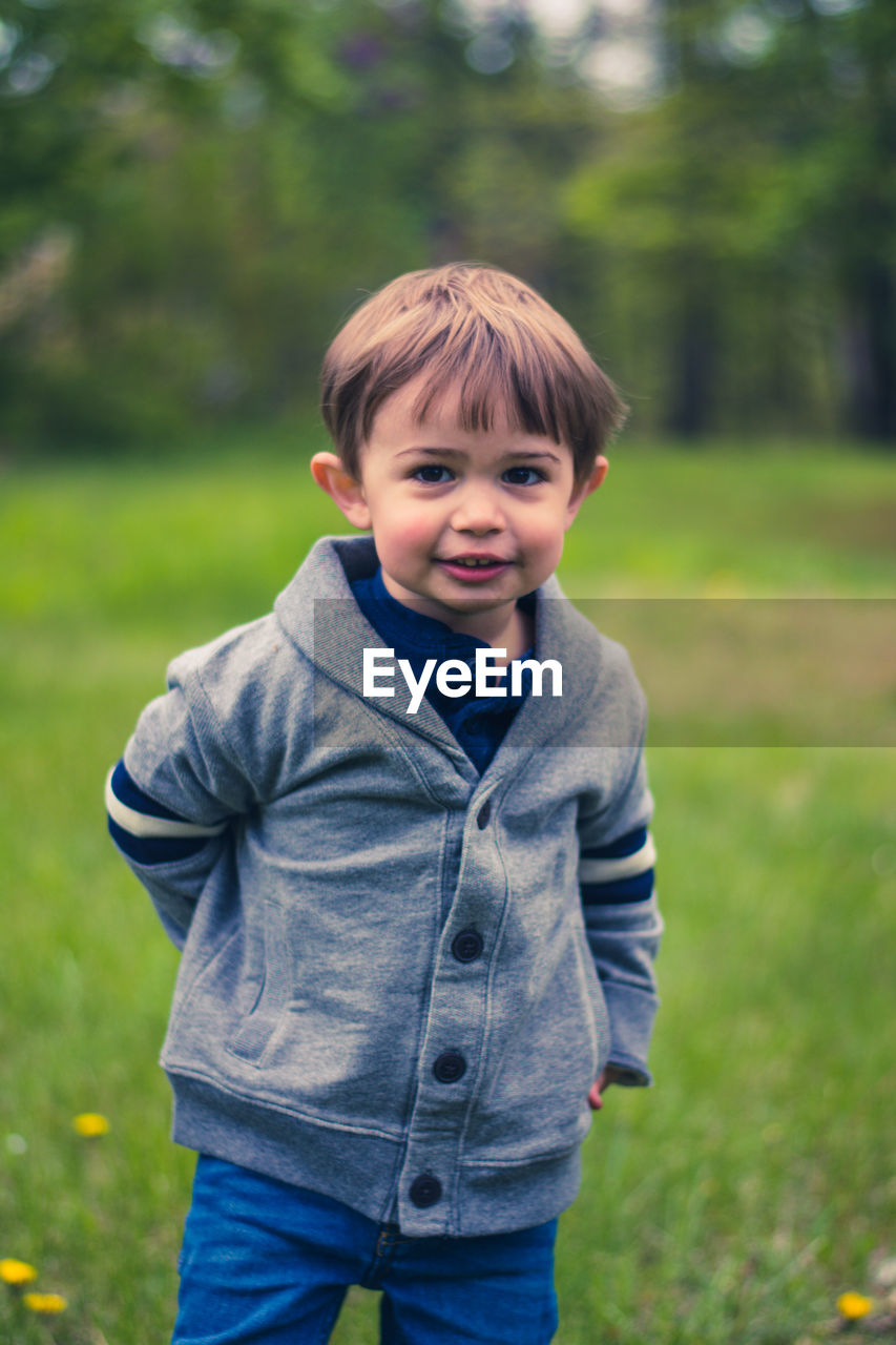 Portrait of smiling boy standing outdoors