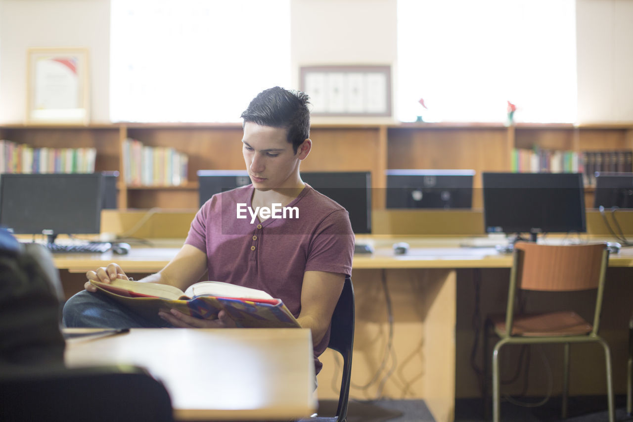 High school student reading a book