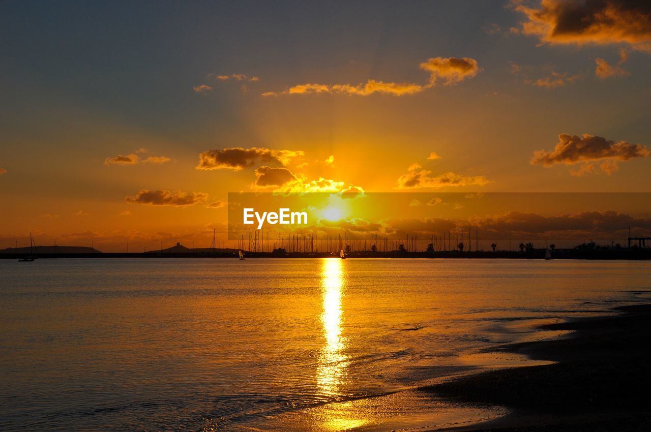 Scenic view of sea against romantic sky at sunset