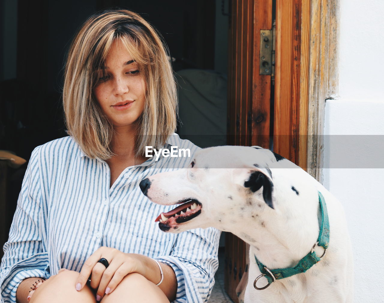 Woman with dog sitting at entrance