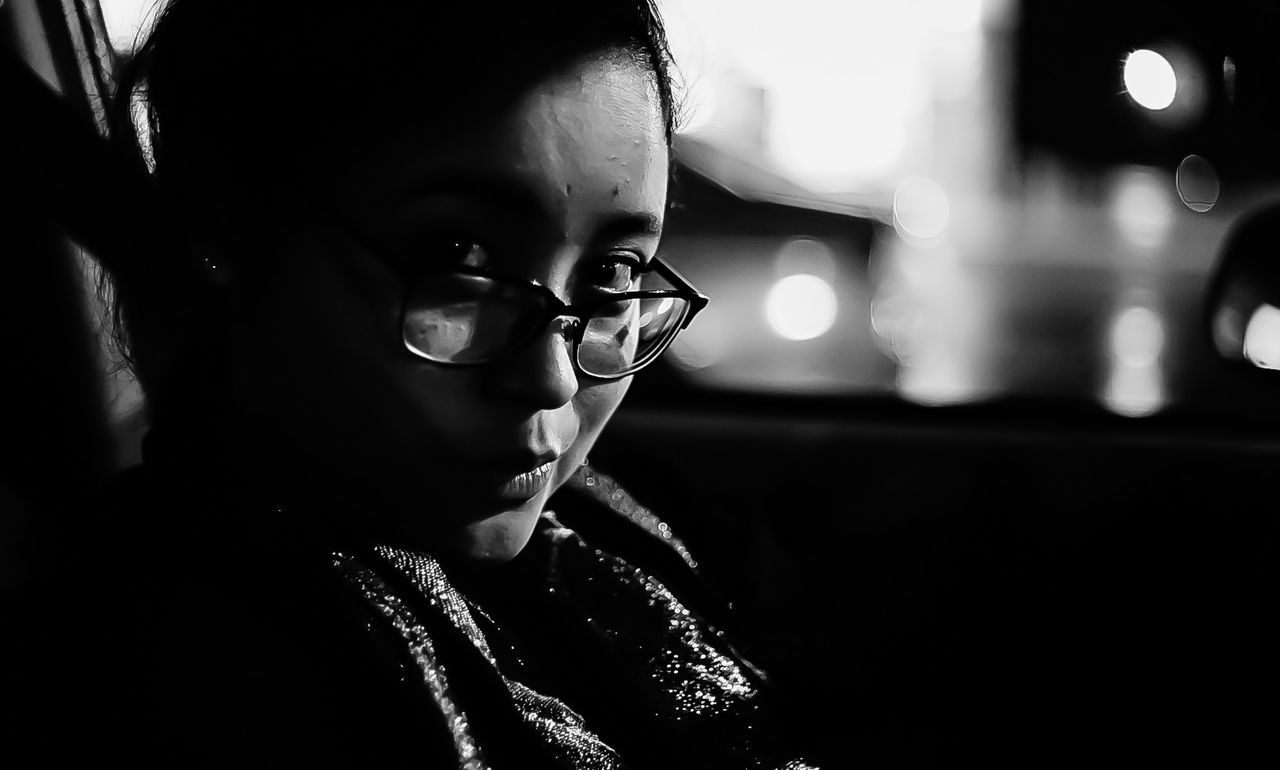 Portrait of woman in car at night