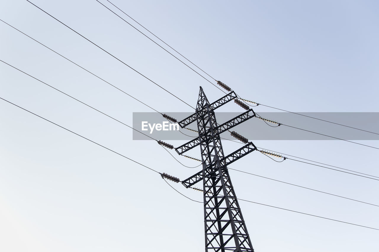 low angle view of power lines against clear sky