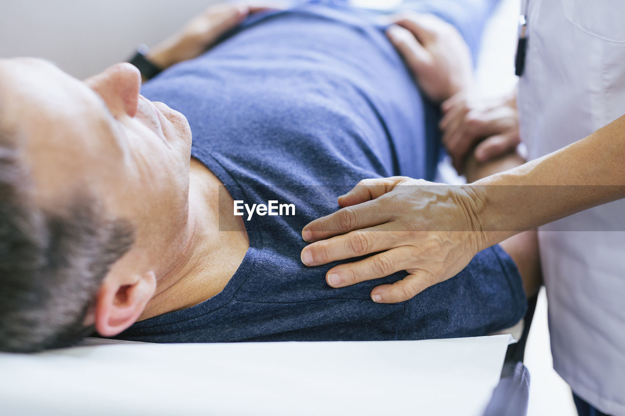 Close-up of doctor comforting patient at hospital