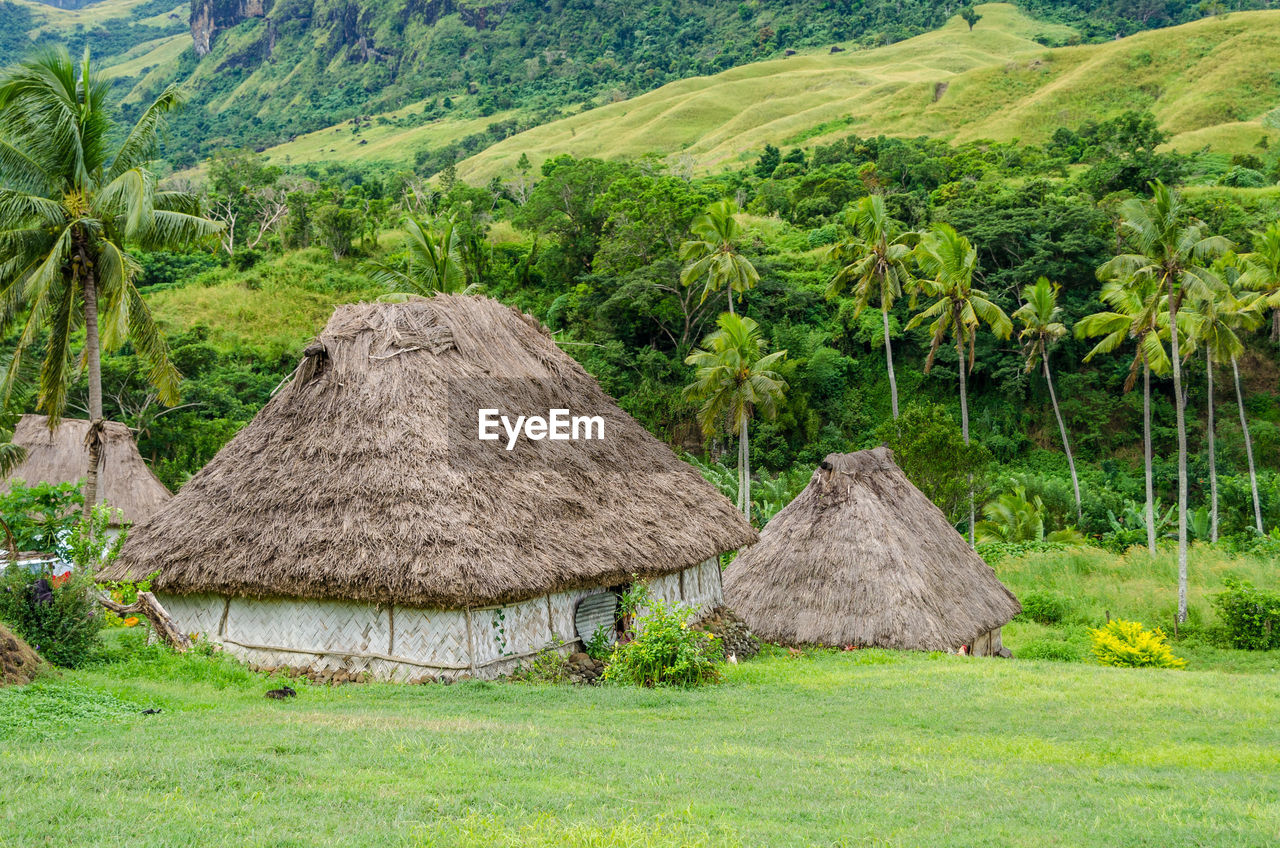 SCENIC VIEW OF FARM AGAINST MOUNTAIN