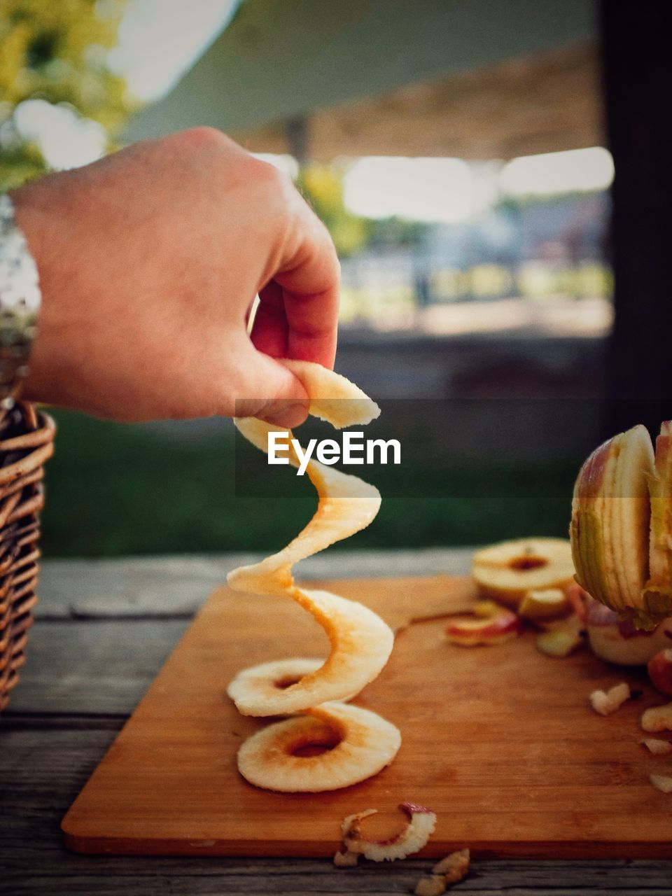 CROPPED IMAGE OF PERSON HOLDING FRUITS ON TABLE