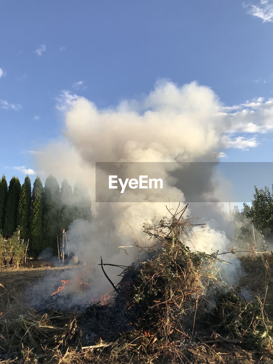 SMOKE EMITTING FROM CLOUDS OVER LAND