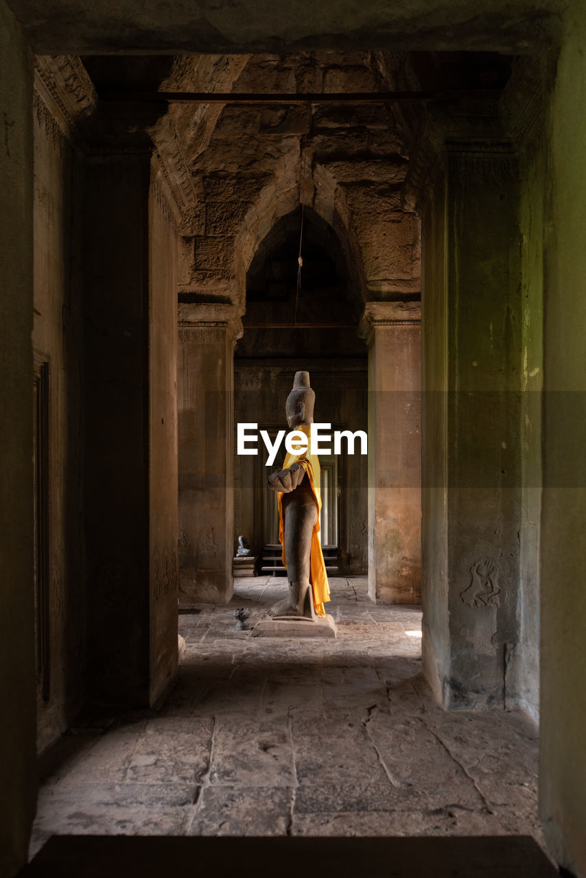 Buddha statue standing in angkor wat hall