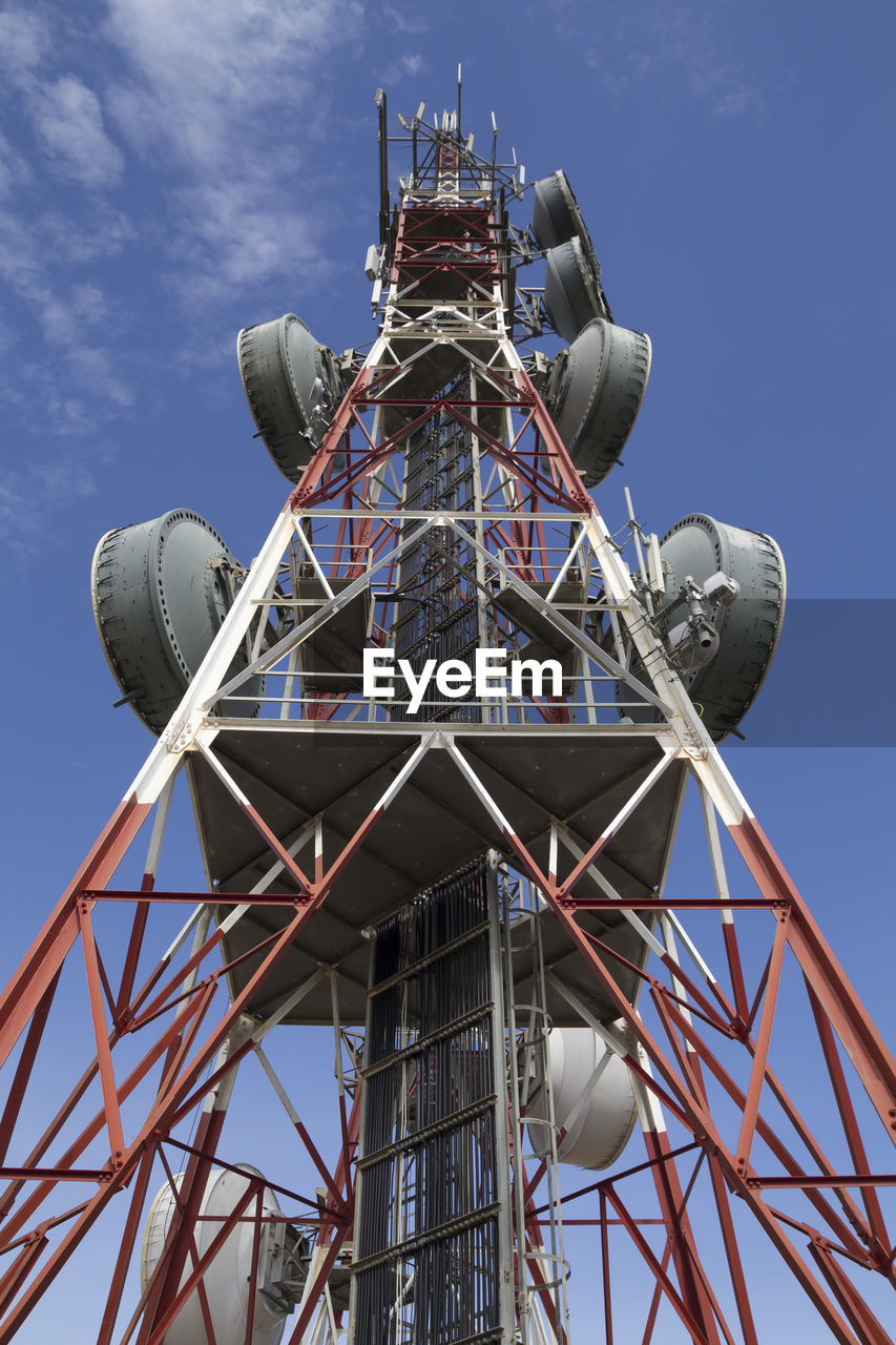 Low angle view of telecommunication tower against sky