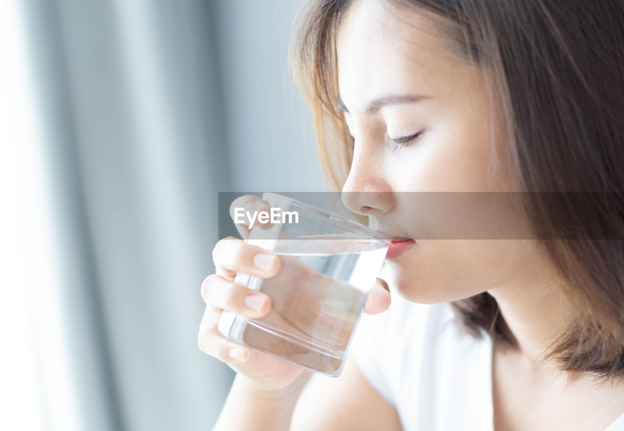 Close-up of woman drinking water