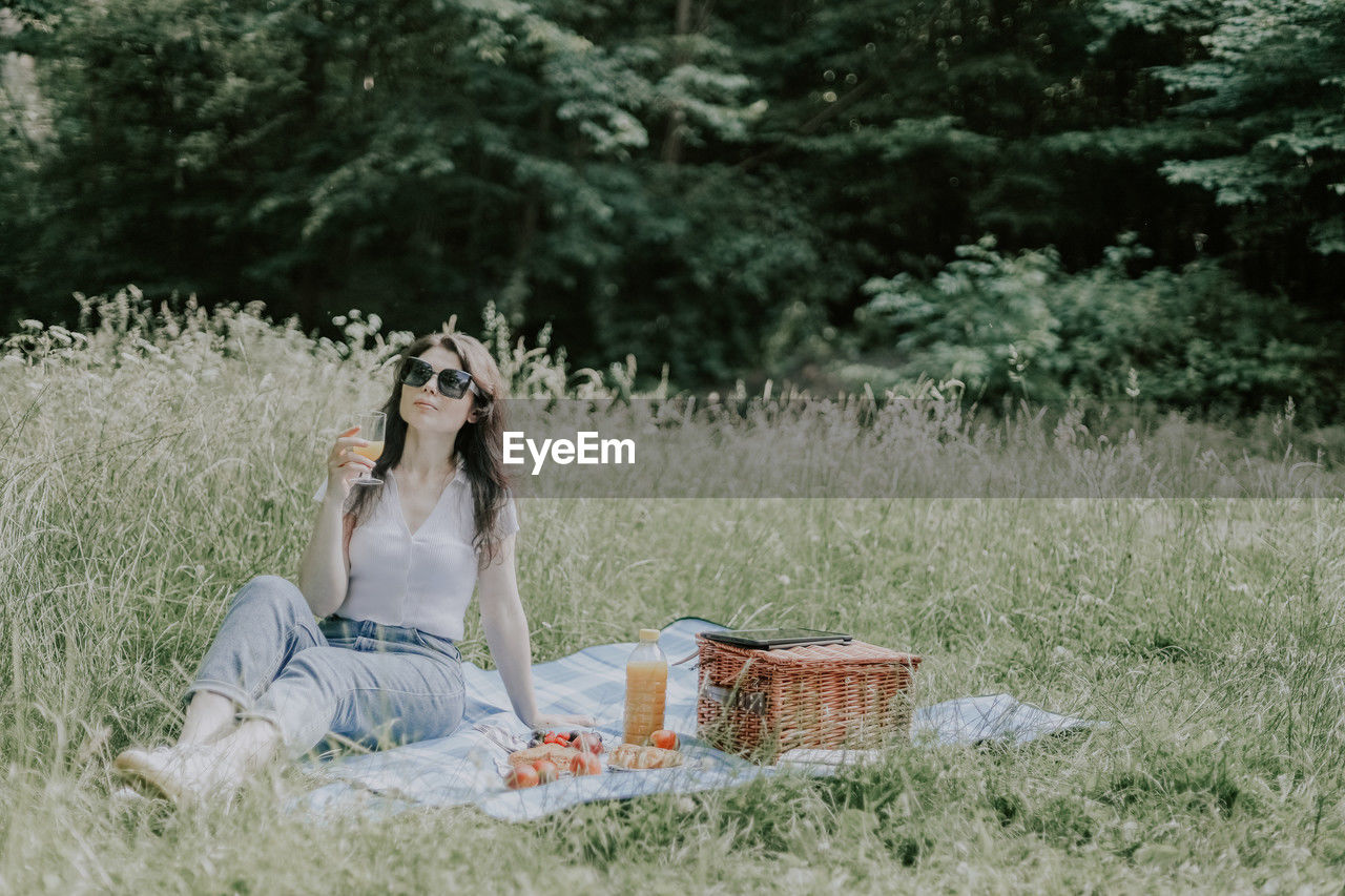 Young brunette girl at a picnic in the forest.