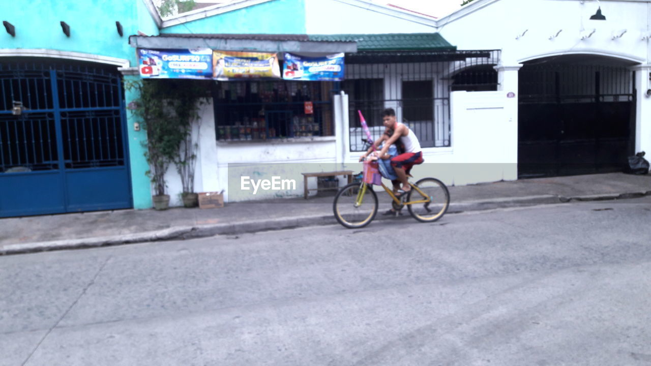 WOMAN RIDING BICYCLE ON BICYCLE