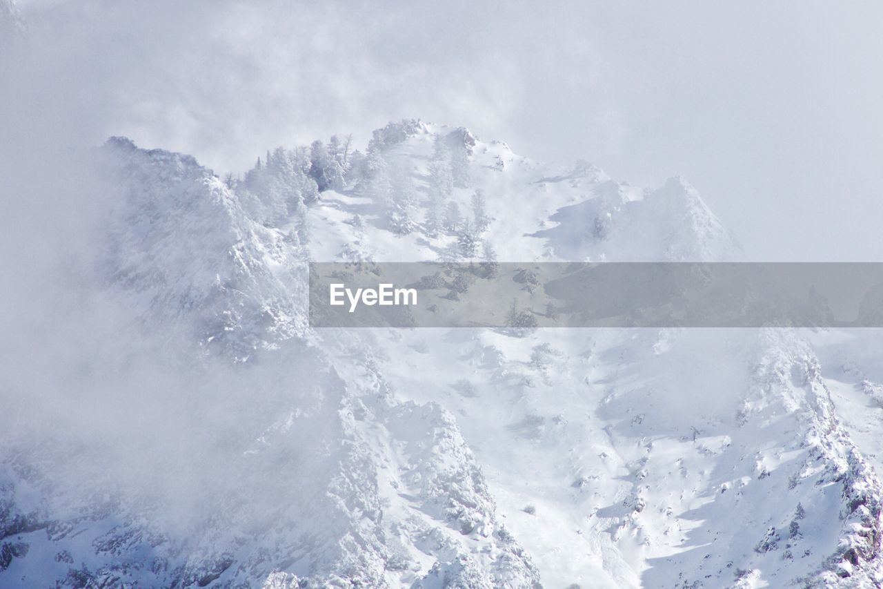 Scenic view of snow mountains against sky