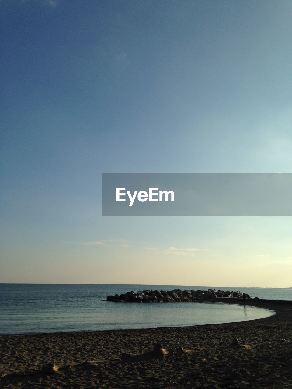 SCENIC VIEW OF BEACH AGAINST SKY DURING SUNSET