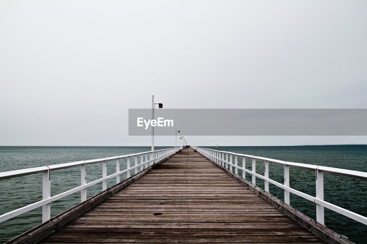 Pier over sea against sky