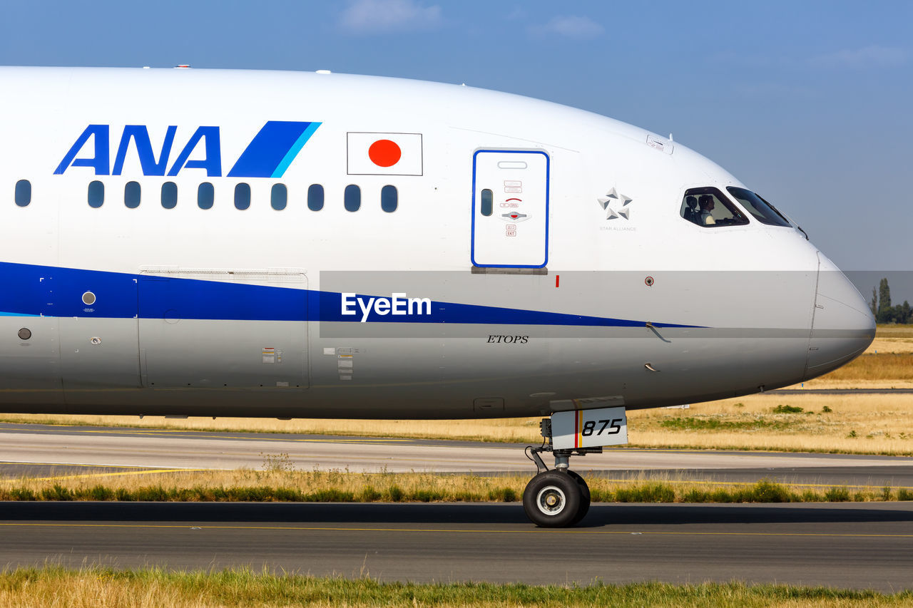 CLOSE-UP OF AIRPLANE ON AIRPORT RUNWAY