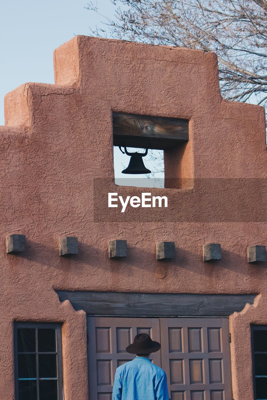 Man standing against bell tower