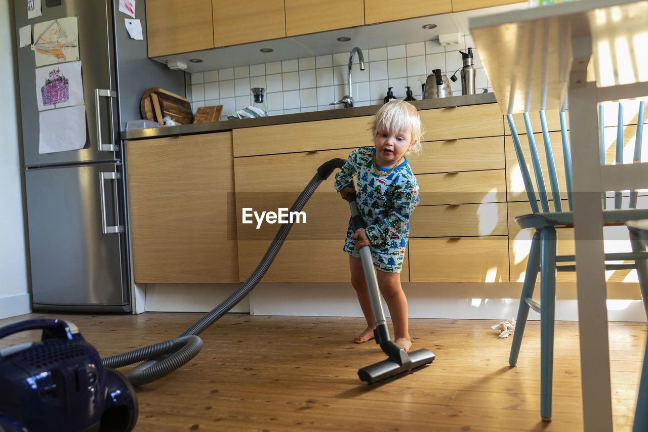 Girl hoovering floor