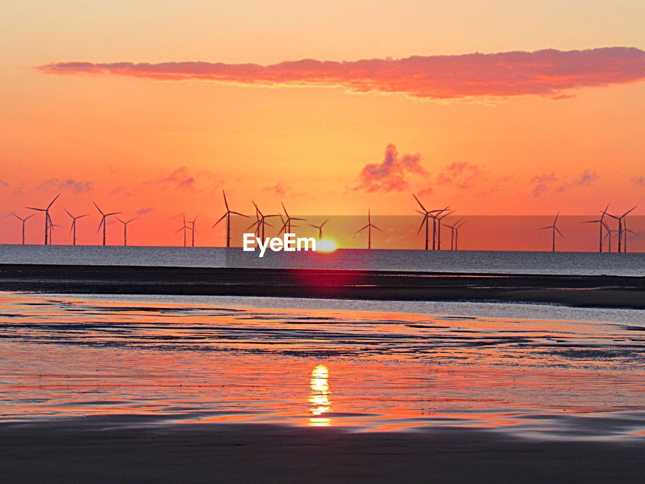 VIEW OF WINDMILL ON SEA AT SUNSET