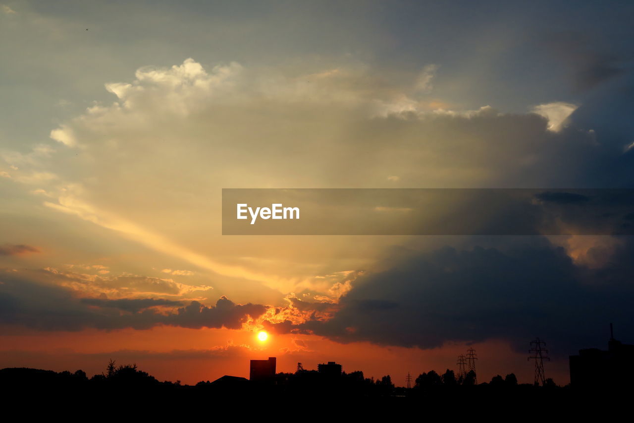 Silhouette landscape against scenic sky