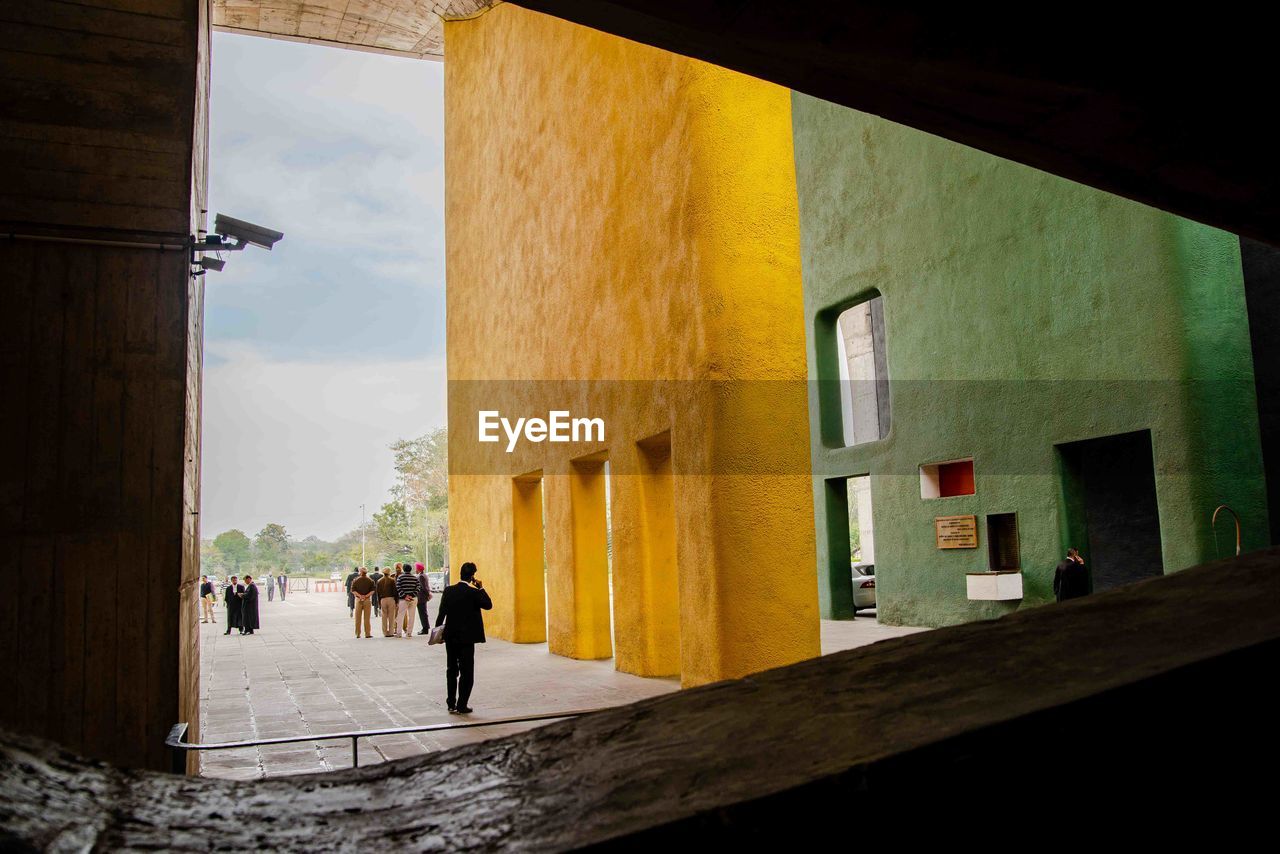 PEOPLE WALKING BY BUILDINGS IN CITY