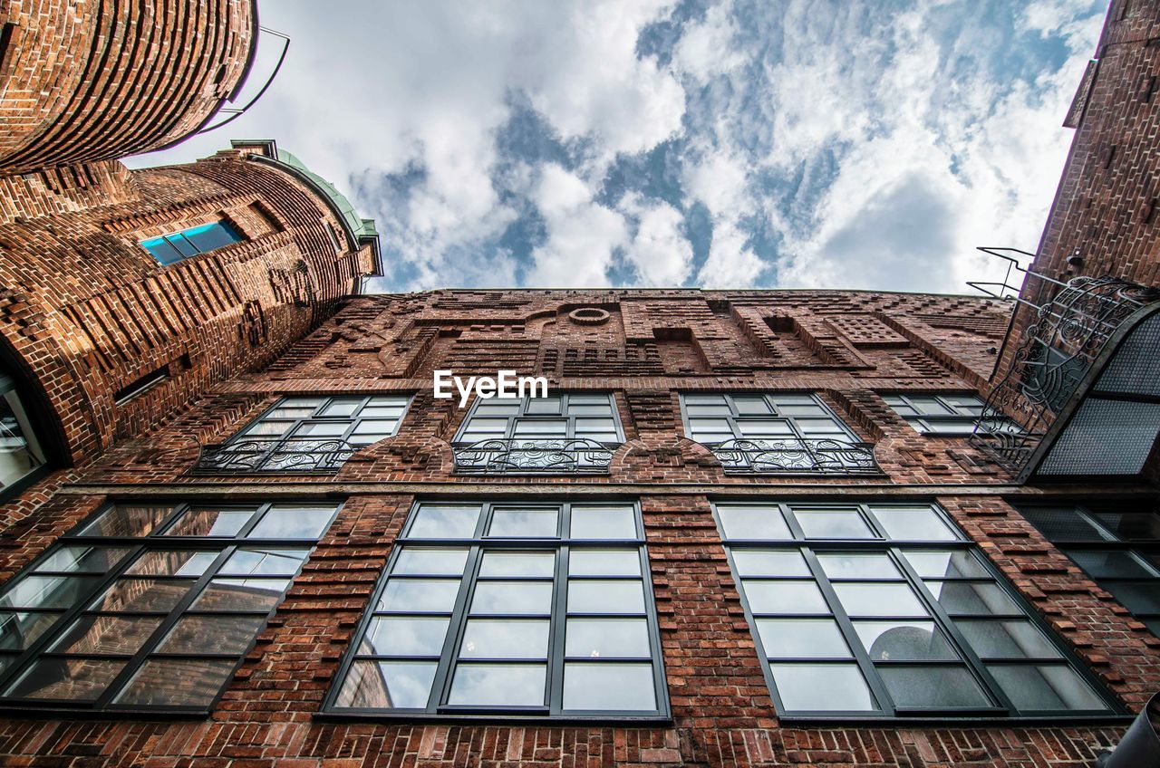 Low angle view of industrial building against sky