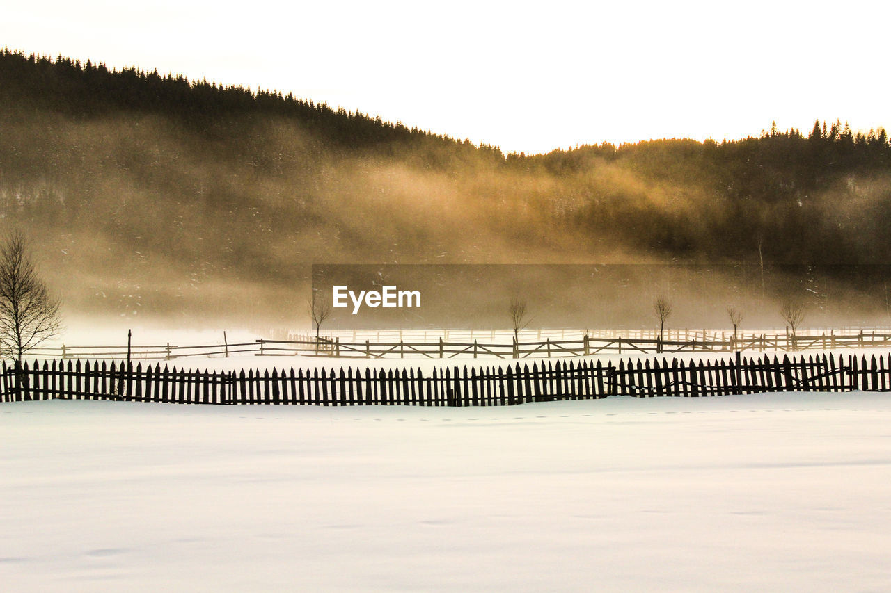 Scenic view of landscape against sky during winter