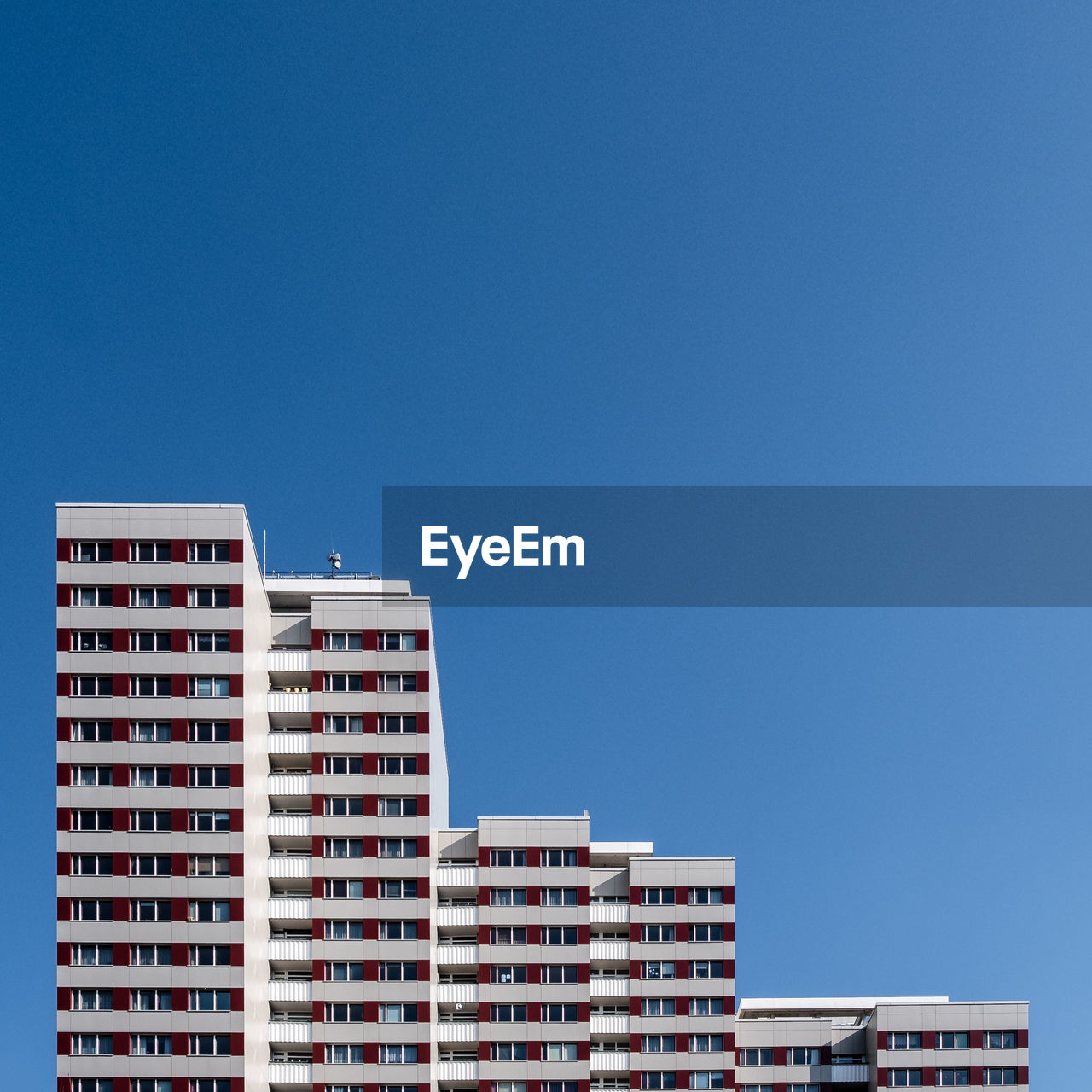 Low angle view of buildings against clear blue sky